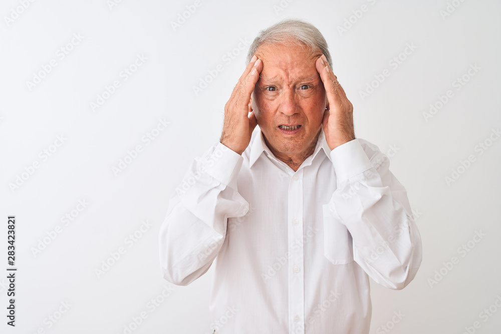Senior grey-haired man wearing elegant shirt standing over isolated white background with hand on head for pain in head because stress. Suffering migraine. Senior grey-haired man wearing elegant shirt standing over isolated white background with hand on head for pain in head because stress. Suffering migraine.