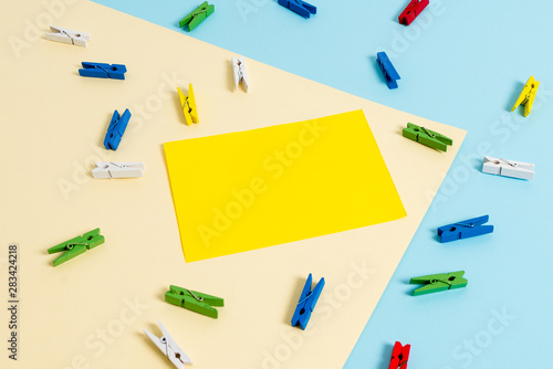 Colored clothespin paper empty reminder yellow blue floor background office