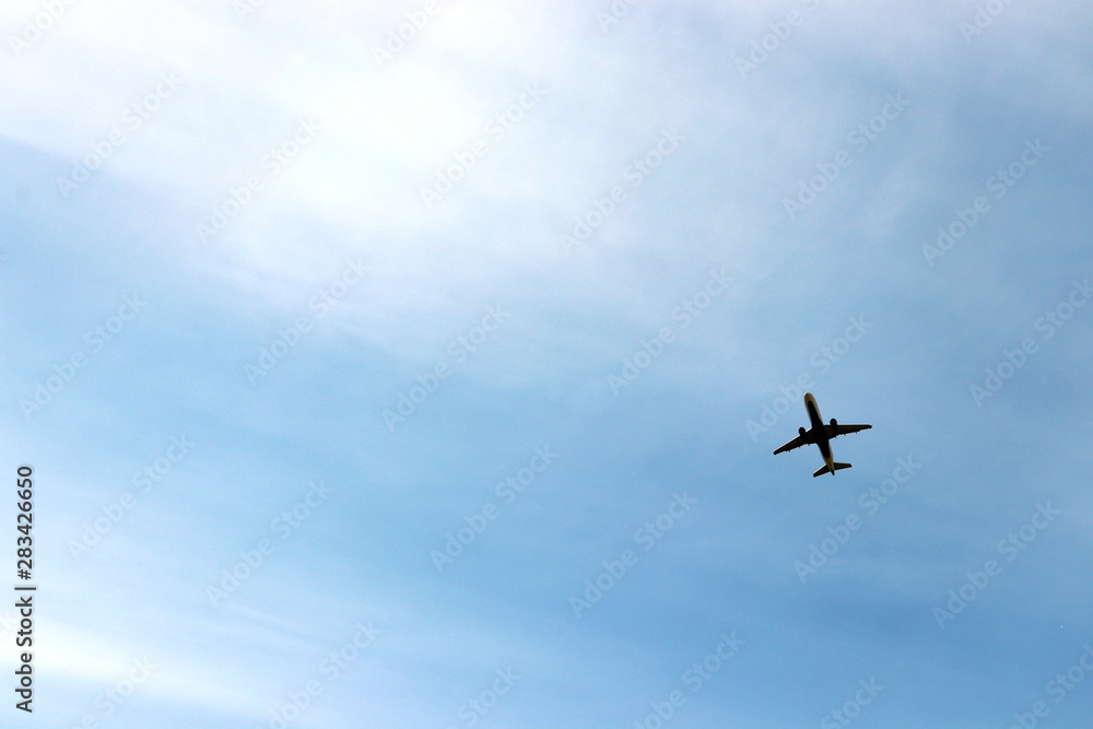 Airplane taking flight from a nearby airport, on a sunny, semi-cloudy day. Airplane taking flight from a nearby airport, on a sunny, semi-cloudy day.