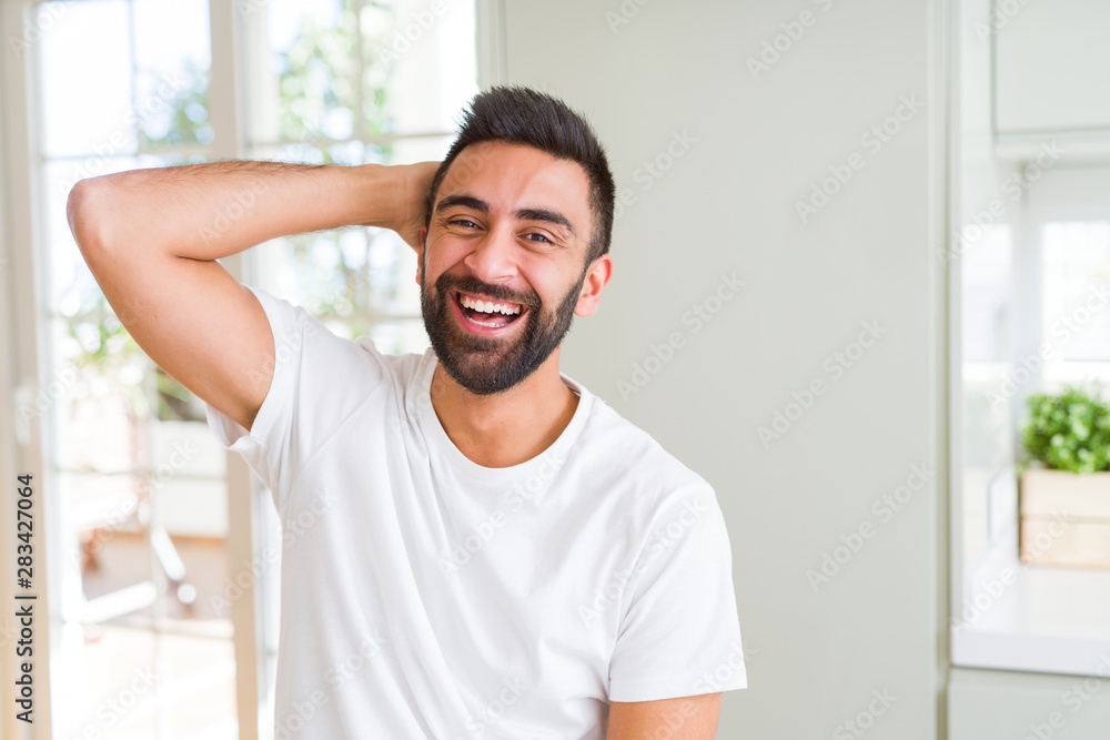 Handsome man smiling cheerful with a big smile on face showing teeth, positive and happy expression Handsome man smiling cheerful with a big smile on face showing teeth, positive and happy expression
