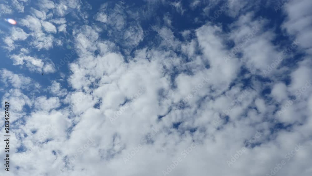 Fluffy white clouds blue sky time lapse motion background. Bright blue sky fluffy white cloud cloudscape cloudy heaven. Fluffy white clouds blue sky time lapse motion background. Bright blue sky fluffy white cloud cloudscape cloudy heaven.