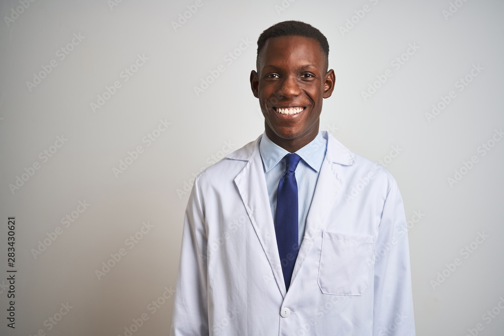 Young african american doctor man wearing coat standing over isolated white background with a happy and cool smile on face. Lucky person. Young african american doctor man wearing coat standing over isolated white background with a happy and cool smile on face. Lucky person.