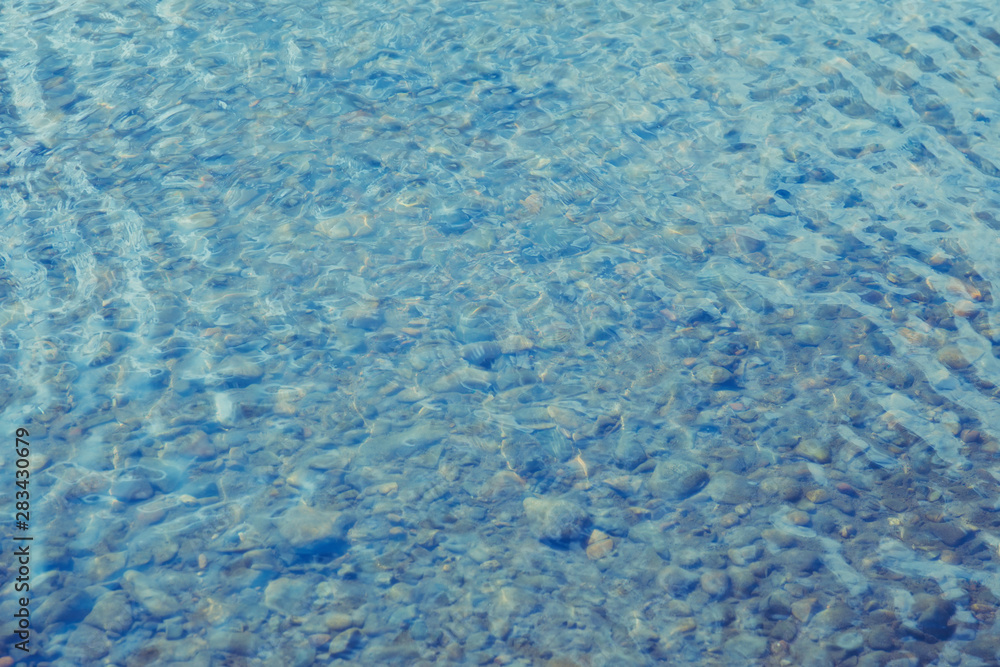 Fototapeta premium Shining blue wavy water surface ripple background