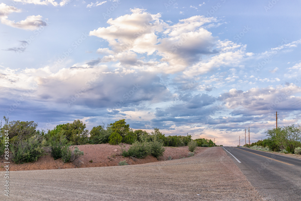 Fototapeta premium Intersection of Encantado drive and Bishops Lodge Road with nobody in Santa Fe, New Mexico during evening sunset and mountains
