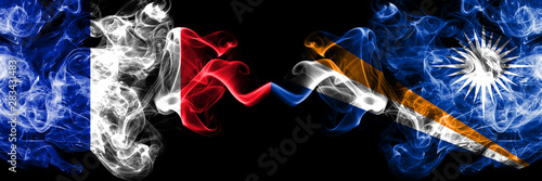 France vs Marshall Islands smoky mystic flags placed side by side. Thick colored silky abstract smoke banner of French and Marshall Islands photo