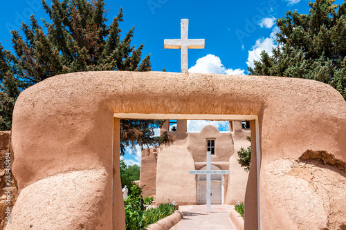 Ranchos de Taos St Francic Plaza and San Francisco de Asis church with cross and gate in New Mexico photo