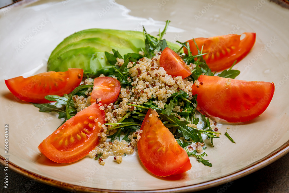 Quinoa side dish with onions and vegetables on wooden table Quinoa side dish with onions and vegetables on wooden table