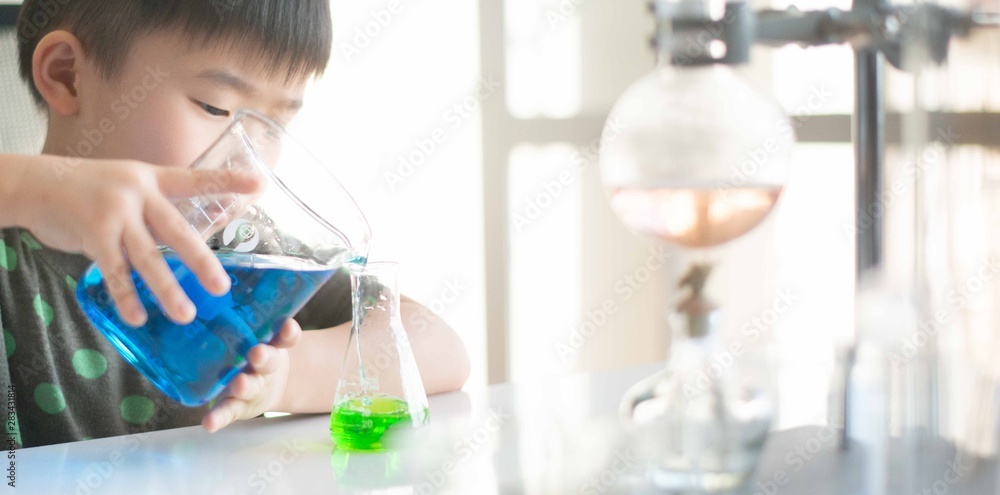 Kid learning science in chemical laboratory. Kid learning science in chemical laboratory.