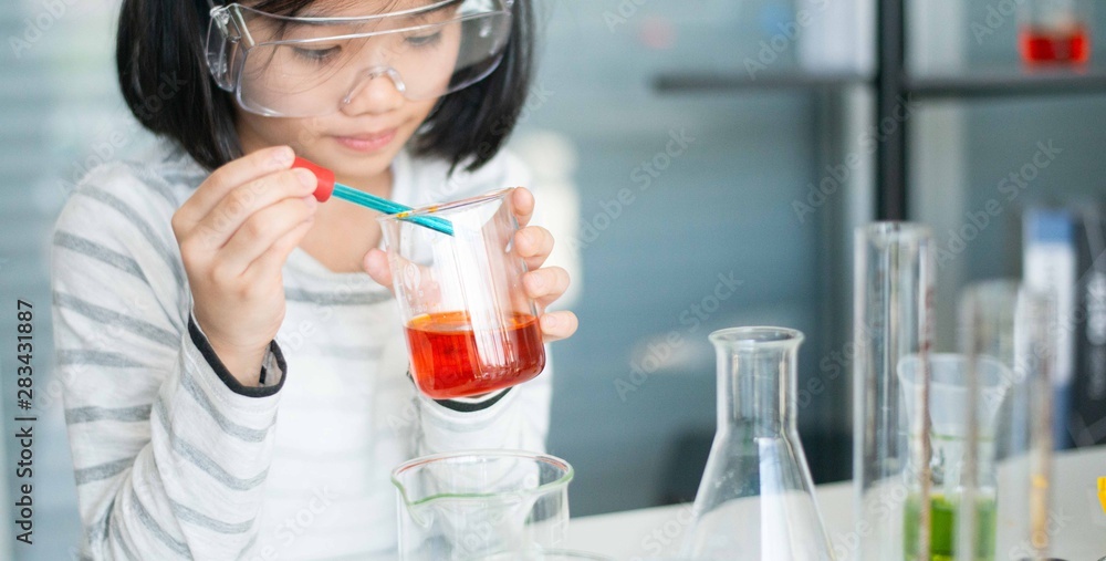 Kid learning science in chemical laboratory. Kid learning science in chemical laboratory.