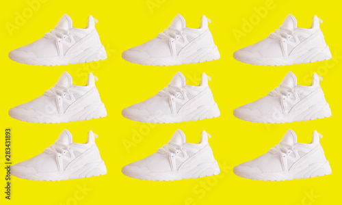 Sporty pattern of shoes on yellow background.