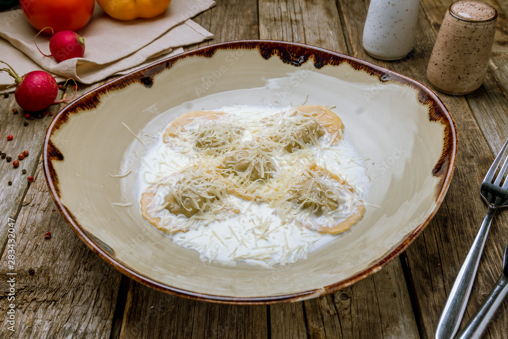 Italian ravioli with salmon on old wooden table Italian ravioli with salmon on old wooden table