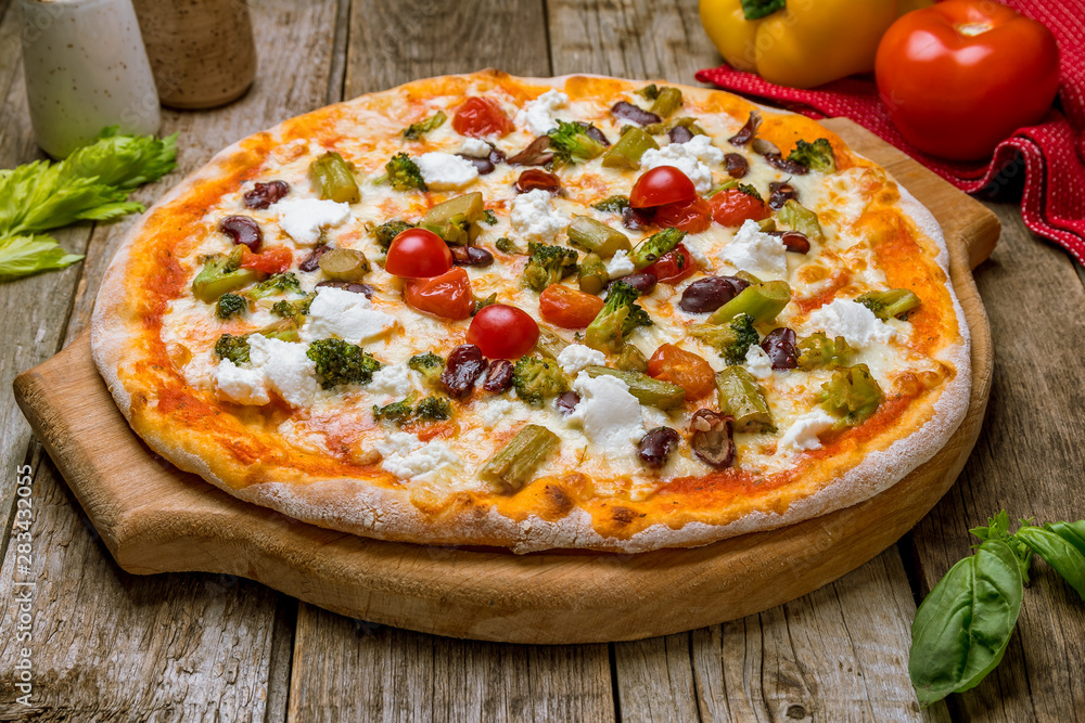 Pizza with vegetables vegetarian on old wooden table