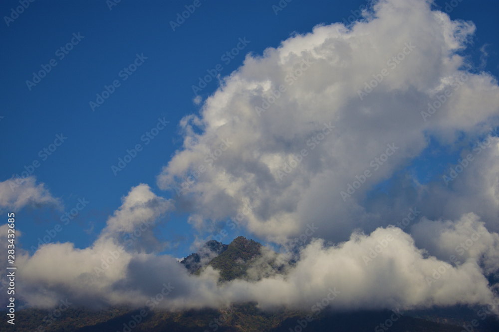 a panoramic view of the Bhutan Mountain in Bhutan capped by big white clouds