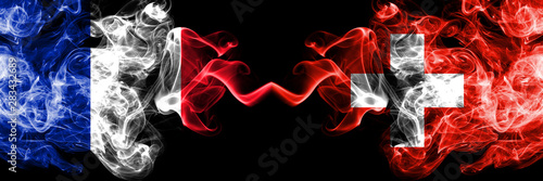 France vs Switzerland, Swiss smoky mystic flags placed side by side. Thick colored silky abstract smoke banner of French and Switzerland, Swiss photo