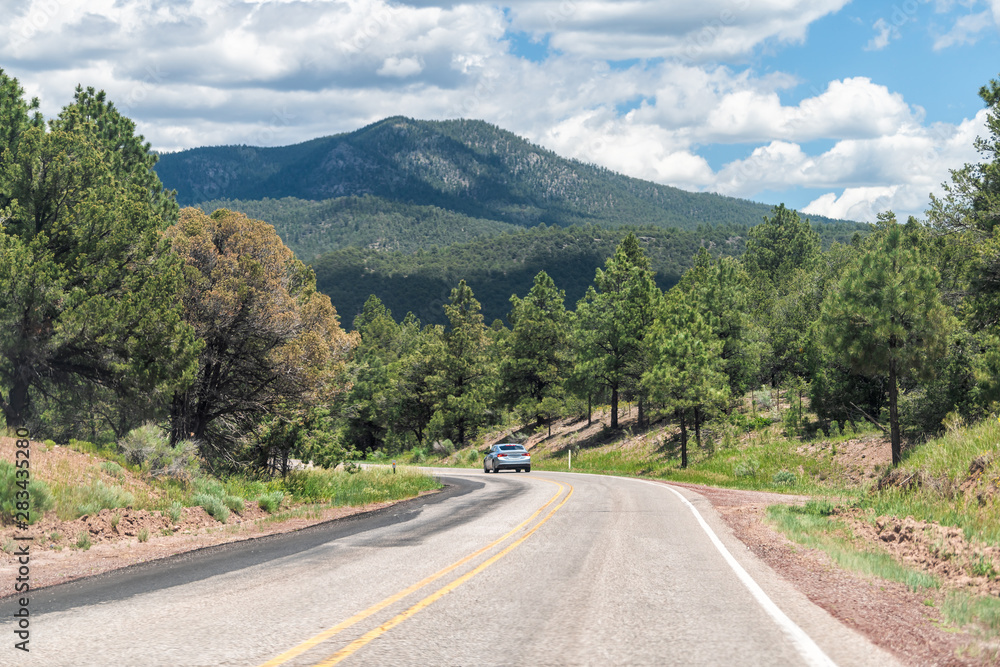 Carson National Forest highway 75 in Penasco, New Mexico with Sangre de Cristo mountains and green pine trees in summer at high road to Taos