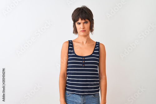 Young beautiful woman wearing striped t-shirt standing over isolated white background skeptic and nervous, frowning upset because of problem. Negative person. © Krakenimages.com