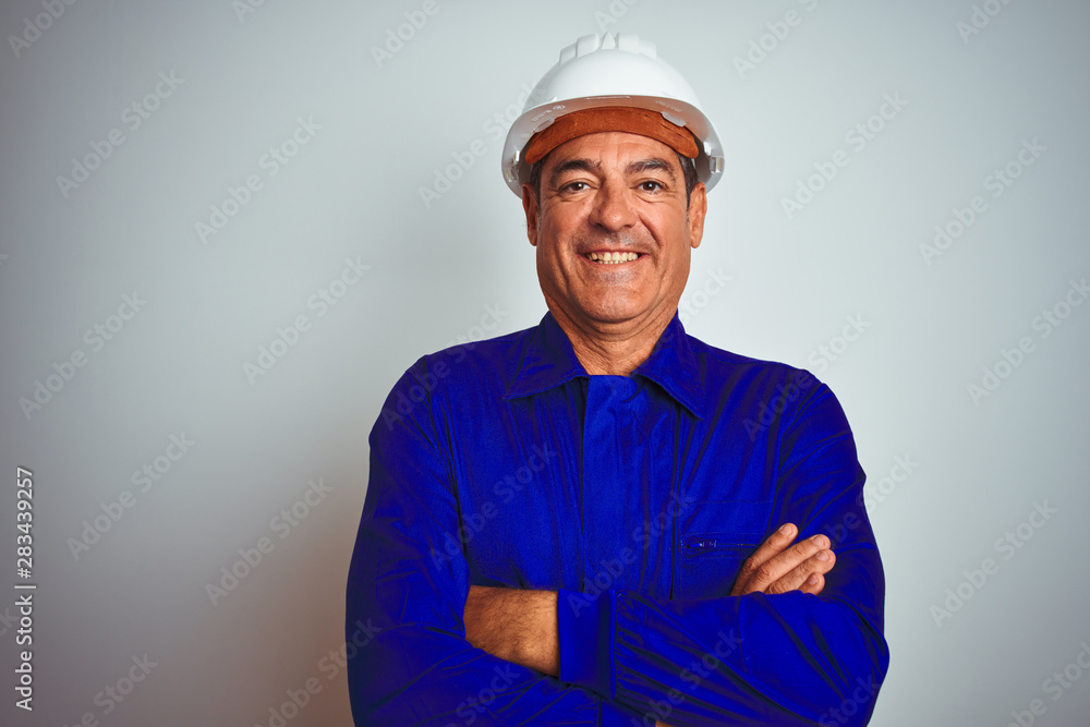 Handsome middle age worker man wearing uniform and helmet over isolated white background happy face smiling with crossed arms looking at the camera. Positive person. Handsome middle age worker man wearing uniform and helmet over isolated white background happy face smiling with crossed arms looking at the camera. Positive person.