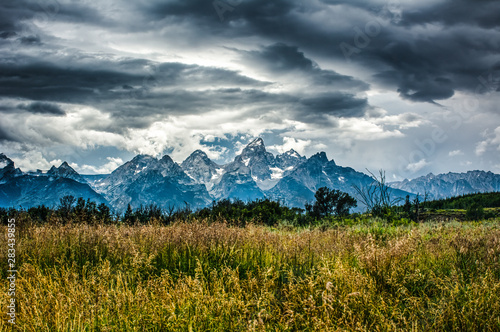 Stunning Storm Clouds Over Grand Tetons - Meadow in Foreground