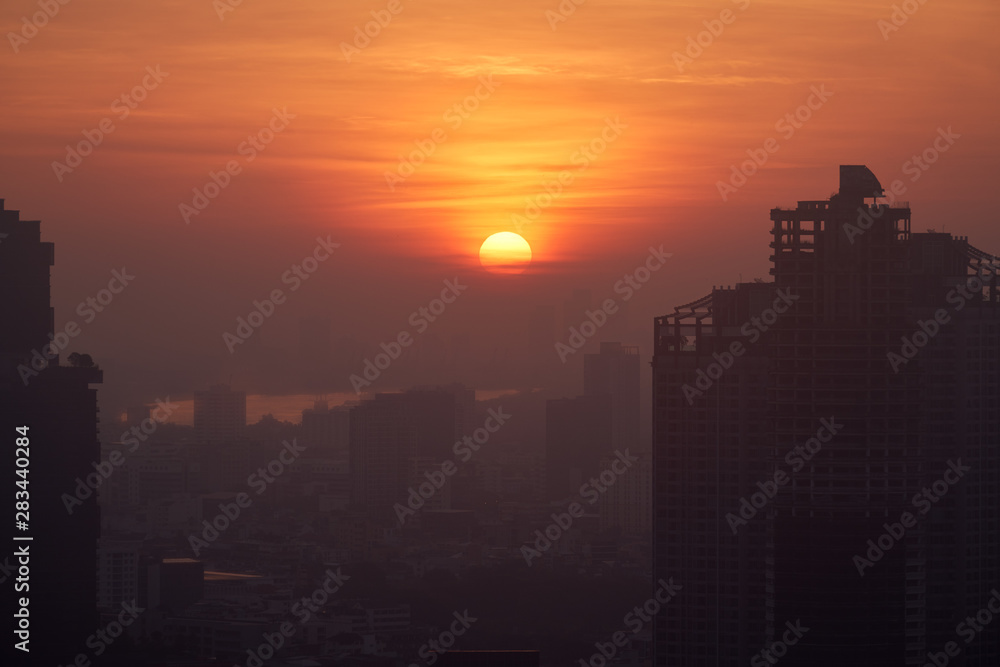 sunrise burst circle on skyline and cityscape silhouette foreground