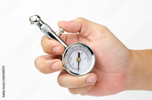 Tire gauge in the white hands