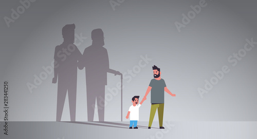 father with son holding hands dreaming about future shadow of young and mature man standing together imagination aspiration concept full length flat horizontal