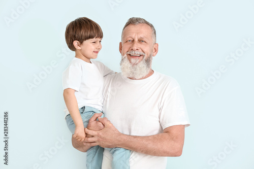 Cute little boy with grandf...