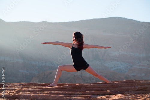 Yoga Pose Woman over Red Rock Canyon