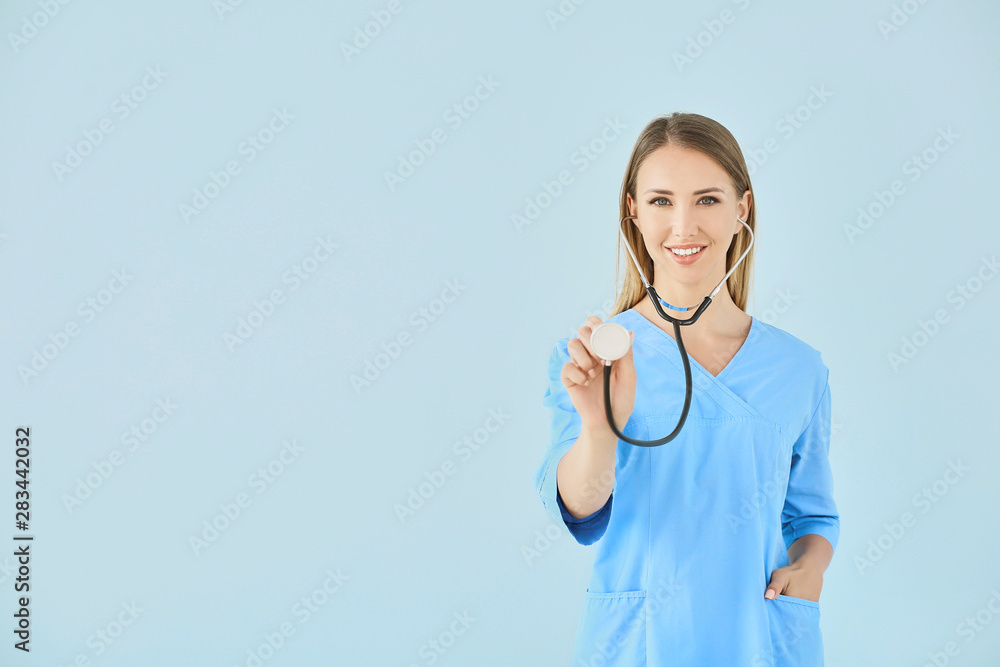Female nurse with stethoscope on color background Female nurse with stethoscope on color background