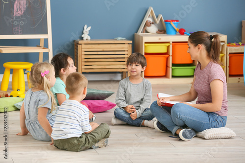 Nursery teacher with cute l...