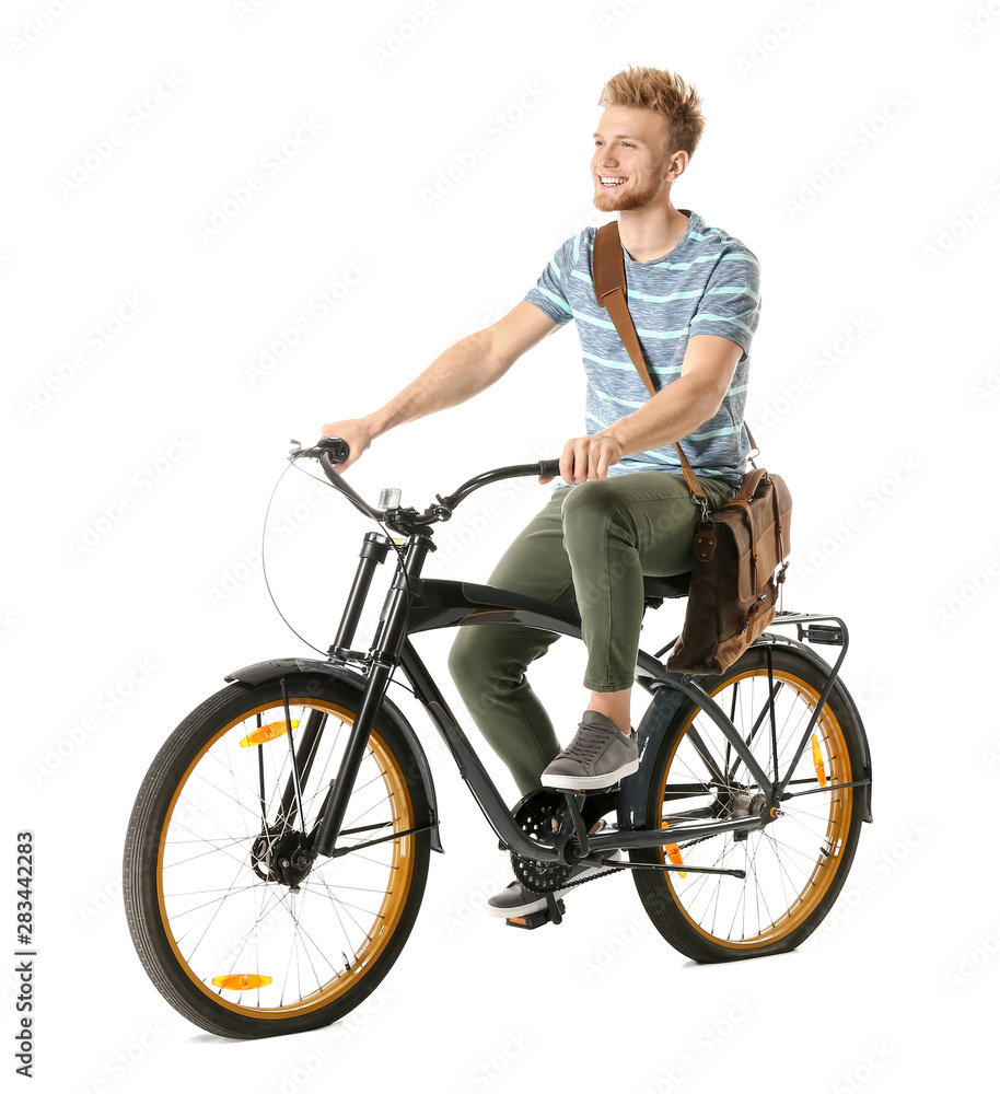 Obraz premium Young man riding bicycle against white background