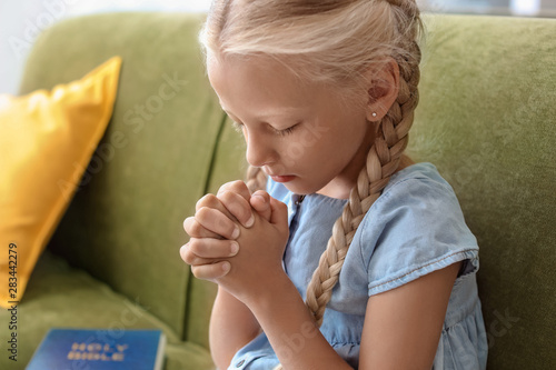 Little girl praying at home