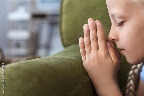Little girl praying at home...