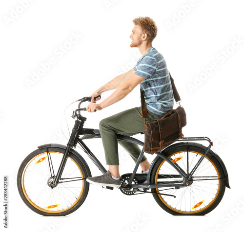 Young man riding bicycle ag...