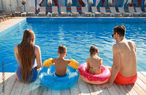 Young family sitting near s...