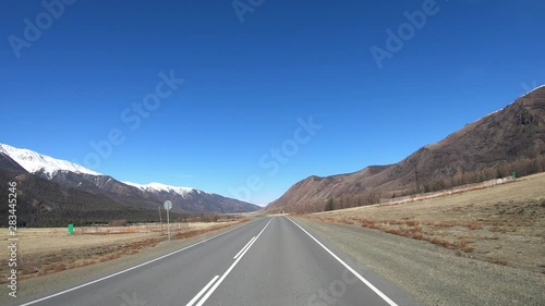 Driving along mountain asphalt road Chuysky Tract along Kurai Ridge on Altai betveen Kosh-Agach and Kurai intermountain hollows photo