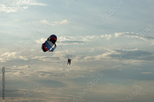 Parasailing on the background of the evening sky. Water activities on the coast of Vietnam