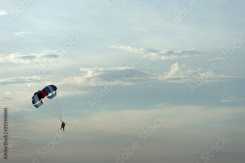 Parasailing on the background of the evening sky. Water activities on the coast of Vietnam