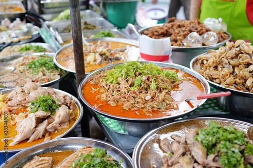Various of thai curry dishes menu in Big Stainless bowl at thai market © lmanju