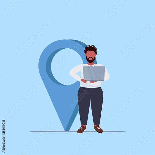 man using geo tag pointer african american guy holding laptop near location marker gps navigation concept flat full length