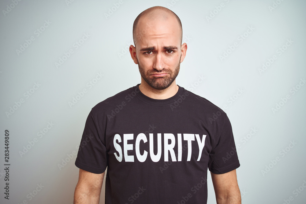 Young safeguard man wearing security uniform over isolated background depressed and worry for distress, crying angry and afraid. Sad expression. Young safeguard man wearing security uniform over isolated background depressed and worry for distress, crying angry and afraid. Sad expression.