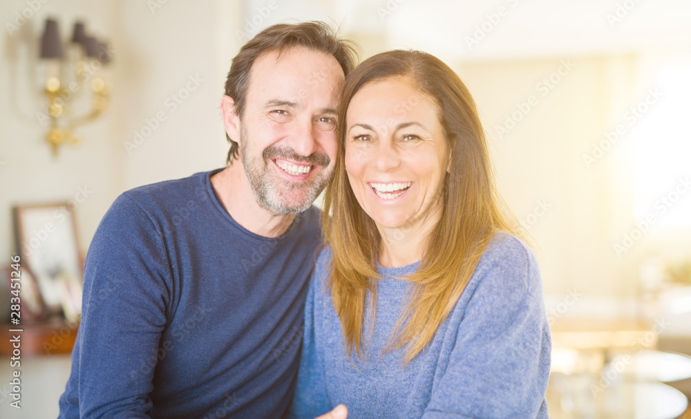 Romantic middle age couple sitting together at home Romantic middle age couple sitting together at home