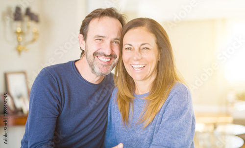 Romantic middle age couple sitting together at home