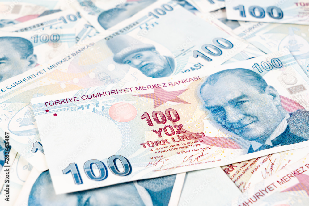 Fototapeta premium Istanbul, Turkey - 17 April, 2019: 100, One hundred banknote Turkish Lira Currency stacked up on white background for business, finance and exchange. Forex and Financial concept.