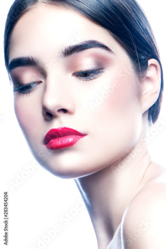 Beauty face of fashion model girl, perfect skin, eye shadow bright lips make-up. Studio close-up portrait