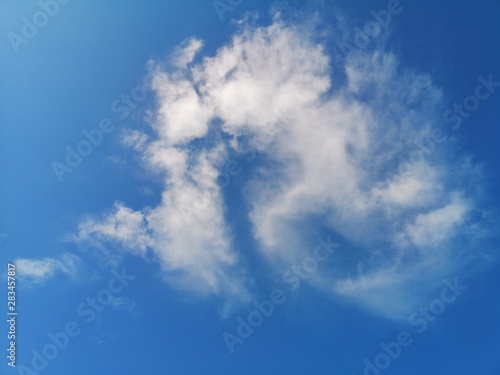 white strange clouds in the blue sky natural background beautiful nature environment space for write