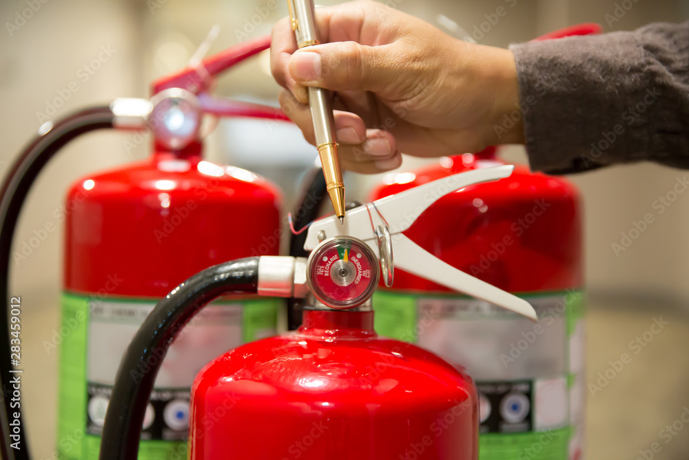 Engineers are checking fire extinguishers. Engineers are checking fire extinguishers.