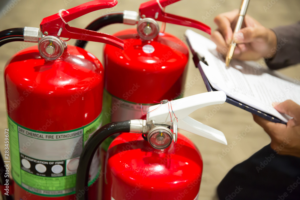 Engineers are checking fire extinguishers. Engineers are checking fire extinguishers.