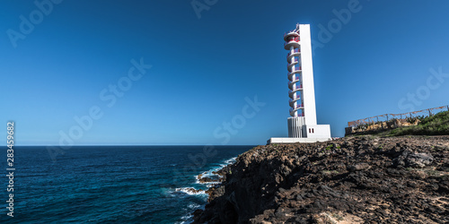 Modern lighthouse on the edge of the cliff