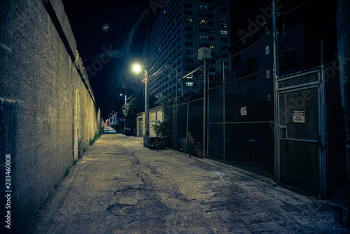 Dark and eerie urban city alley at night 