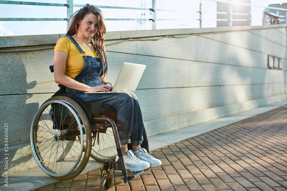 Fototapeta premium cool awesome hipster girl working from home, part time job, full length photo. copy space. girl looking for companies hiring disabled people